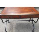 A reproduction leather topped and brass banded desk having cross-framed metal supports Location: