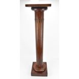 A brass-mounted wooden column pedestal, with flat platform top and fluted column support, 106 cm