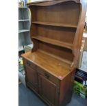 A reproduction Maplelux dresser having a plate rack above a single drawer and two cupboard doors,