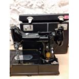 A 1956 Singer 222K sewing machine in original fitted case, spool intact, serial number EM01099