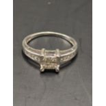 An 18ct white gold ring set with four central diamonds and four diamonds to each shoulder