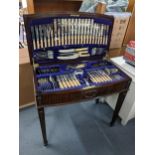 A 1920s mahogany cutlery table containing silver plated Sheffield cutlery having applied mouldings