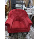 A contemporary button back red upholstered armchair Location:
