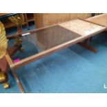 A vintage teak trolley, together with a vintage coffee table with partial glass and partial tiled