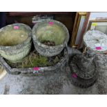 A weathered garden concrete planter on a pedestal base, a pair of circular concrete planters and a