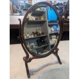 An Edwardian inspired oval swing dressing table mirror on four splayed legs, 57cm high Location: