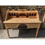 Victorian kneehole pine desk fitted with pigeonhole and drawer to top, over four short drawers, on