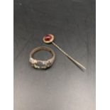A 9ct gold ring A/F together with a late 19th/early 20th century yellow metal stick pin, testing