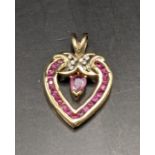 A 9ct gold pendant set with diamonds and rubies total weight 2.4g Location: