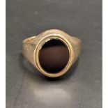 A 9ct gold signet ring set in black onyx, total weight 5.4g Location: