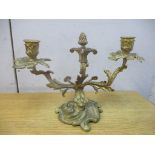 A late 19th/early 20th century French two-branch ormolu candleholder on a dolphin and rococo base