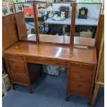 A retro Loughborough teak dressing table having three mirrors above seven drawers 130cm h x 121.