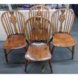 A set of four 19th century ash and elm Windsor spindle back chairs having pierced splat backs and