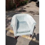 A modern pale green upholstered tub chair Location: