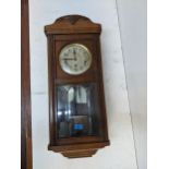 An early 20th century oak clock with bevelled glass panels Location: