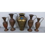 A hammered brass Indian vase together with four copper and brass jugs. Location: