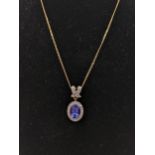 A 9ct gold necklace with a drop pendant inset with a tanzanite and diamonds 5.2g Location: