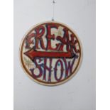 A circular wooden painted circus sign "Freak Show" 32.5cms diameter. Location: