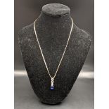 A 9ct gold necklace together with a 9ct gold pendant set with a blue sapphire and paste stones,