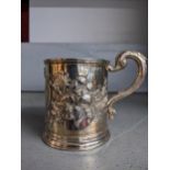 A Victorian Scottish silver mug, cast scroll handle, repousse leaf and thistle decorations