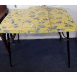 A 1950's yellow Formica kitchen table with floral design Location: BWR