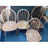 Three mid 20th century Ercol beech and elm spindle back chairs and a rocking chair Location: RAB