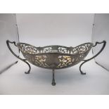 A George V silver twin handled oval bowl on four cast feet, pierced decoration, Sheffield 1921,