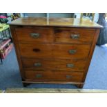 An Edwardian walnut chest of two short and three long drawers with Arts and Crafts handles, 105h x