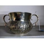 A Pearce & Sons Silver replica Charles II porringer, twin s-handles, repousse leaf decoration and