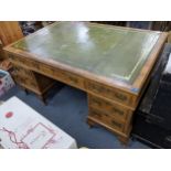 An early/mid 20th century walnut veneered Queen Anne style twin pedestal partner's desk having a