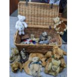 A wicker basket containing a collection of vintage teddy bears including Chad Valley, Herman, Steiff