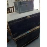 Two mid 20th century ebonized trunks, one with cushioned top together with a metal ammunition box