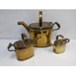 A graduated set of three Edwardian brass maids watering cans Location: