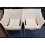 A pair of Kartell Dr No white stacking chairs designed by Philippe Starck having brushed silver tone
