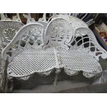 Two matching white painted metal garden benches, three seaters with pierced and floral