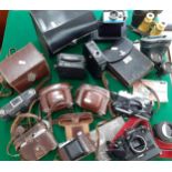 A quantity of vintage cameras to include a Canon A1 A/F, a Canon FX A/F, a pathoscope, and a