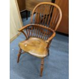 A Stewart Linford child's Windsor spindle back armchair having turned legs and a crinoline stretcher