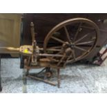 A 19th century pine, elm and mixed wood treadle spinning wheel Location: