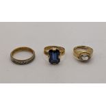 Three 18ct gold rings to include an emerald cut blue gemstone and two others, total weight 8.7g,