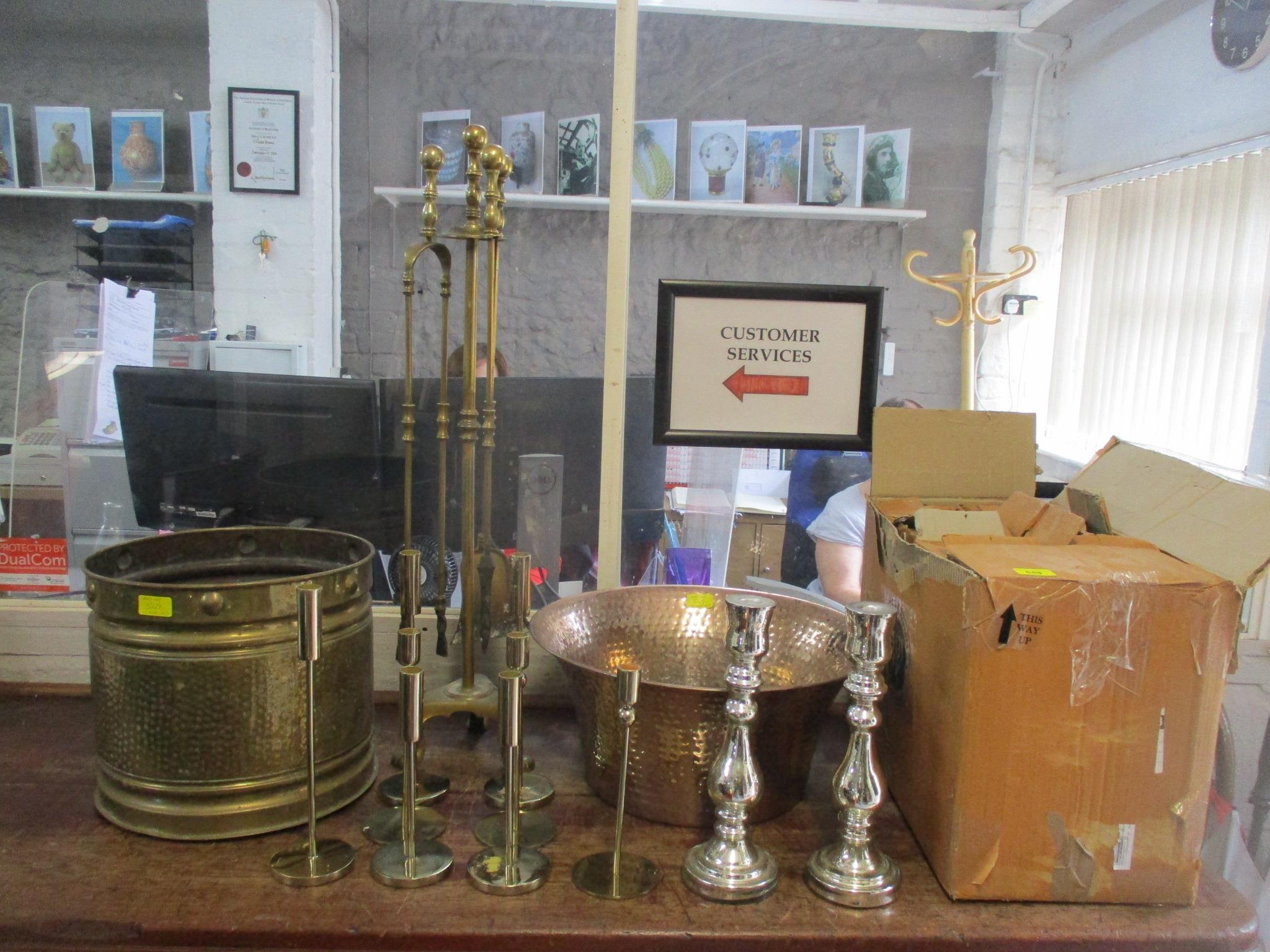 A mixed lot of copper and brassware to include a companion fireside set,16 candlesticks and others