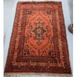 A Persian hand woven rug having a central motif decorated with birds on a red ground, 192cm x