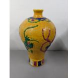 A 20th century Chinese yellow ground baluster vase having a Greek key design and raised relief