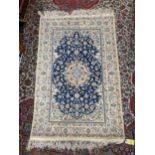A Persian rug with a central medallion and vines on a blue ground, 123cm x 82cm Location: G