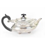 A Victorian silver teapot by the Goldsmiths & Silversmiths Co, London 1898, of oval form with part