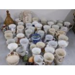A mixed lot to include a Royal Doulton James Burrough decanter, commemorative mugs, and other
