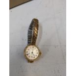 A 9ct gold cased ladies Excalibur wrist watch on an expanding bracelet. Location: