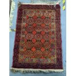 An Afghan hand woven rug having repeating motifs, geometric design and tasselled ends, 126cm x 85.