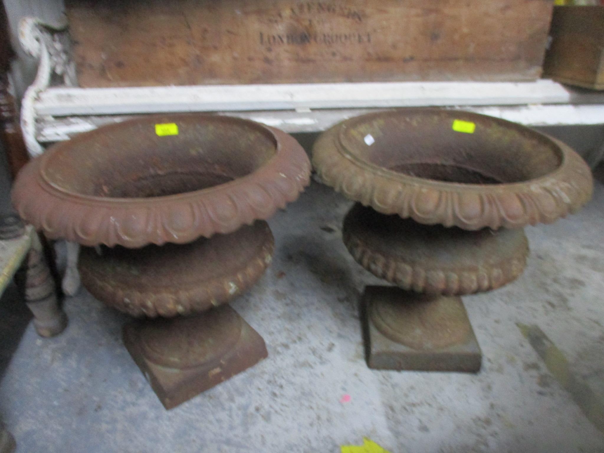 A pair of weathered cast iron urn shaped garden pedestal pots of classical forms, Location: