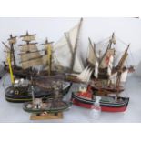 Seven model painted boats to include a Santa Maria model and others together with a glass ship in