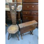 A late 19th century Welsh carved Love chair, together with a Sutherland table having bobbin turned